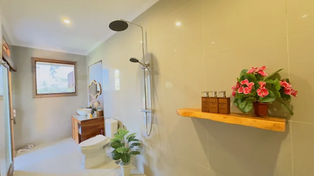 Bathroom with natural stone finishes at Jambangan Bali Villa Ubud