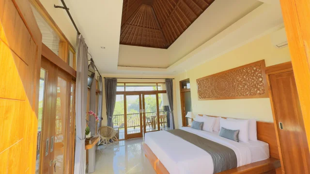 Spacious master bedroom with panoramic windows at Jambangan Bali Villa Ubud