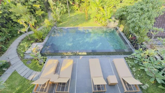 Swimming pool with sunbeds at Jambangan Bali Villa Ubud